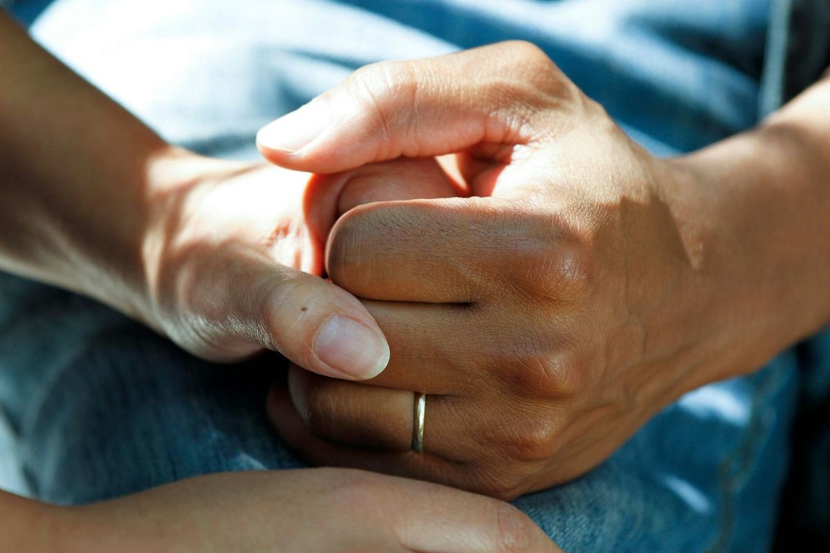 A couple clasping hands.