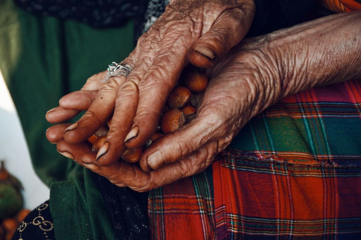 Close-up of an older person’s hands held together.