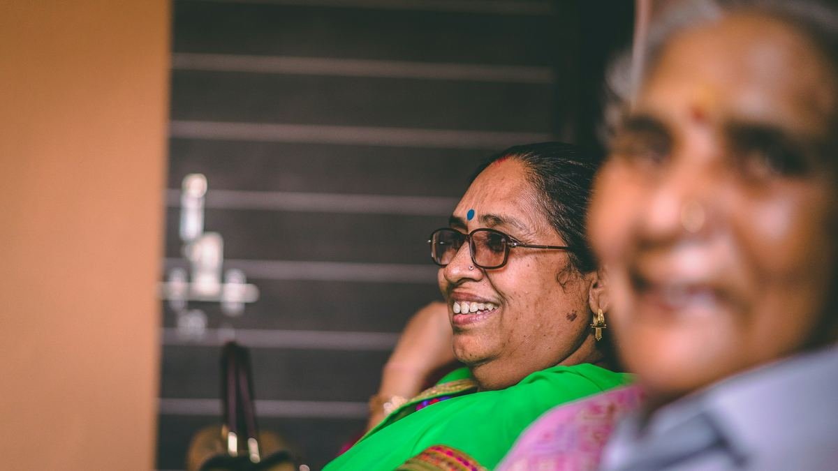 Two older women smiling together.